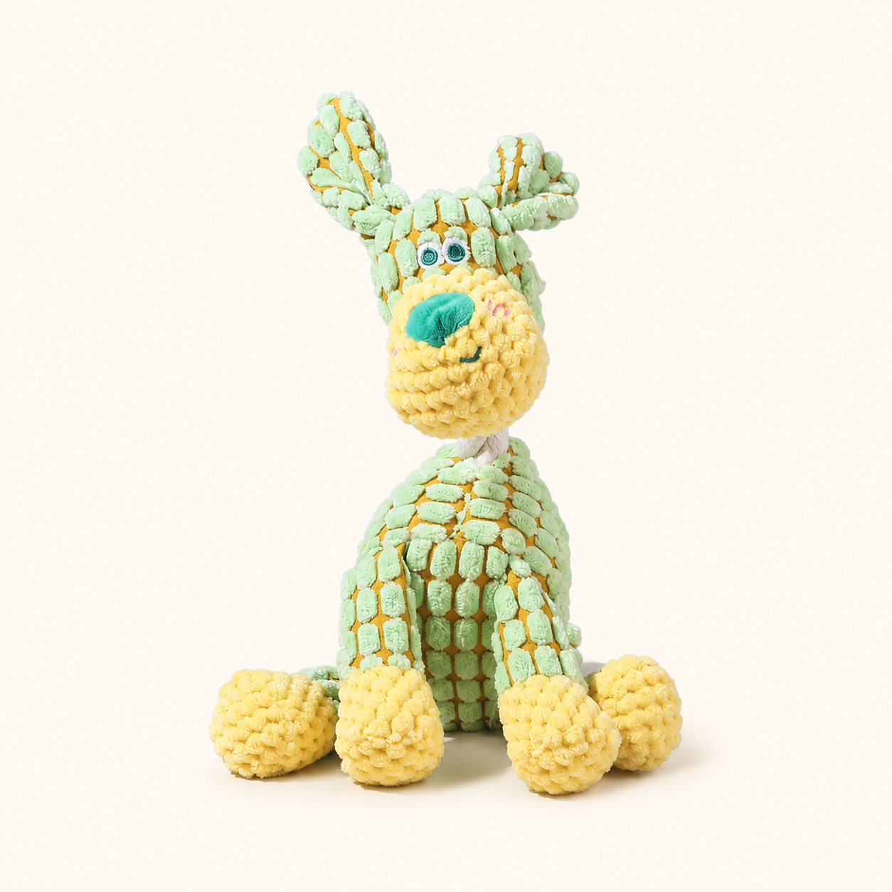 Green dog corduroy squeaky dog toy on cream background